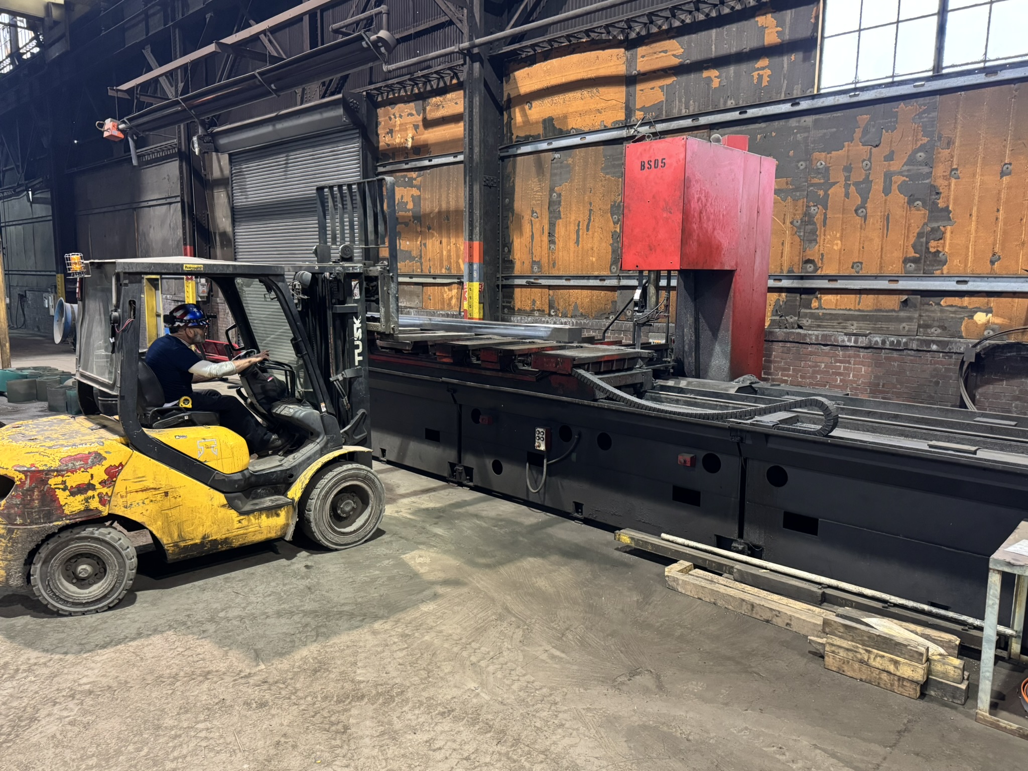 Bandsaw cutting through titanium billet at MSI Corporation
