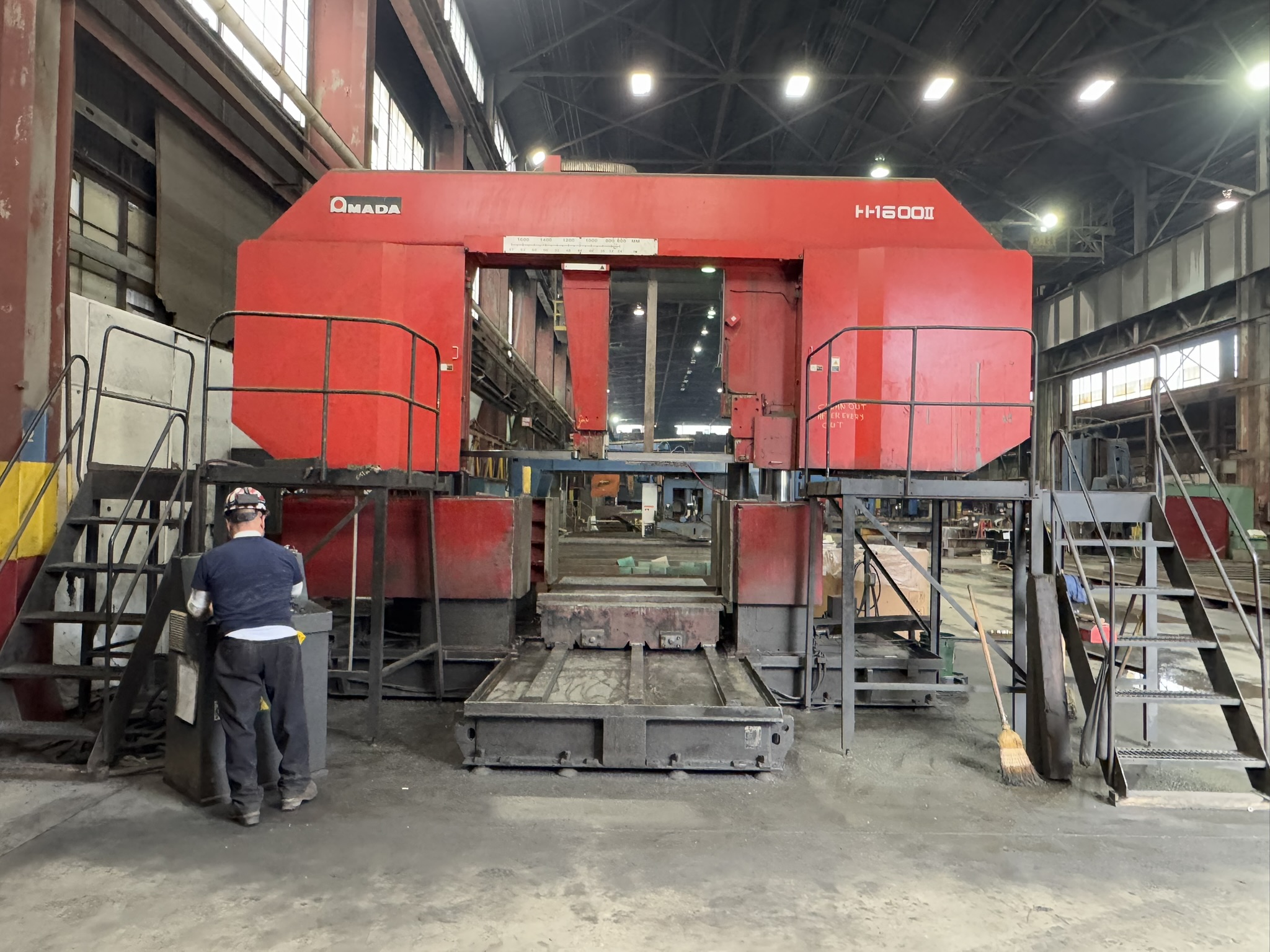 Bandsaw cutting through titanium billet at MSI Corporation