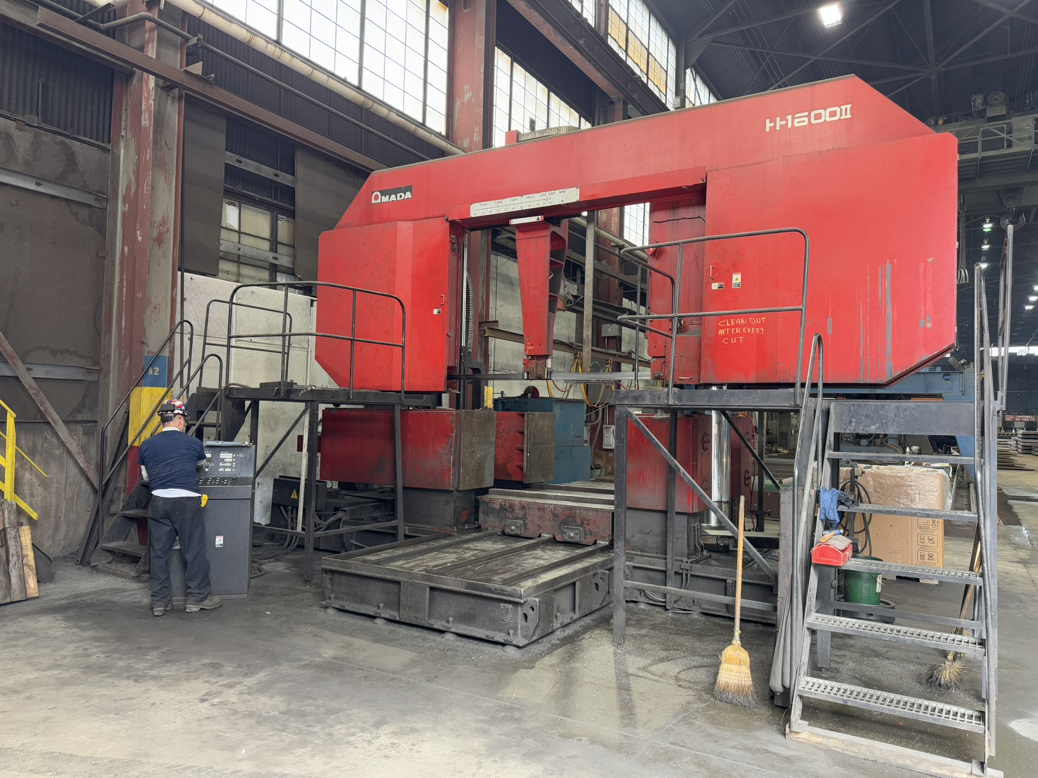 Bandsaw cutting through titanium billet at MSI Corporation