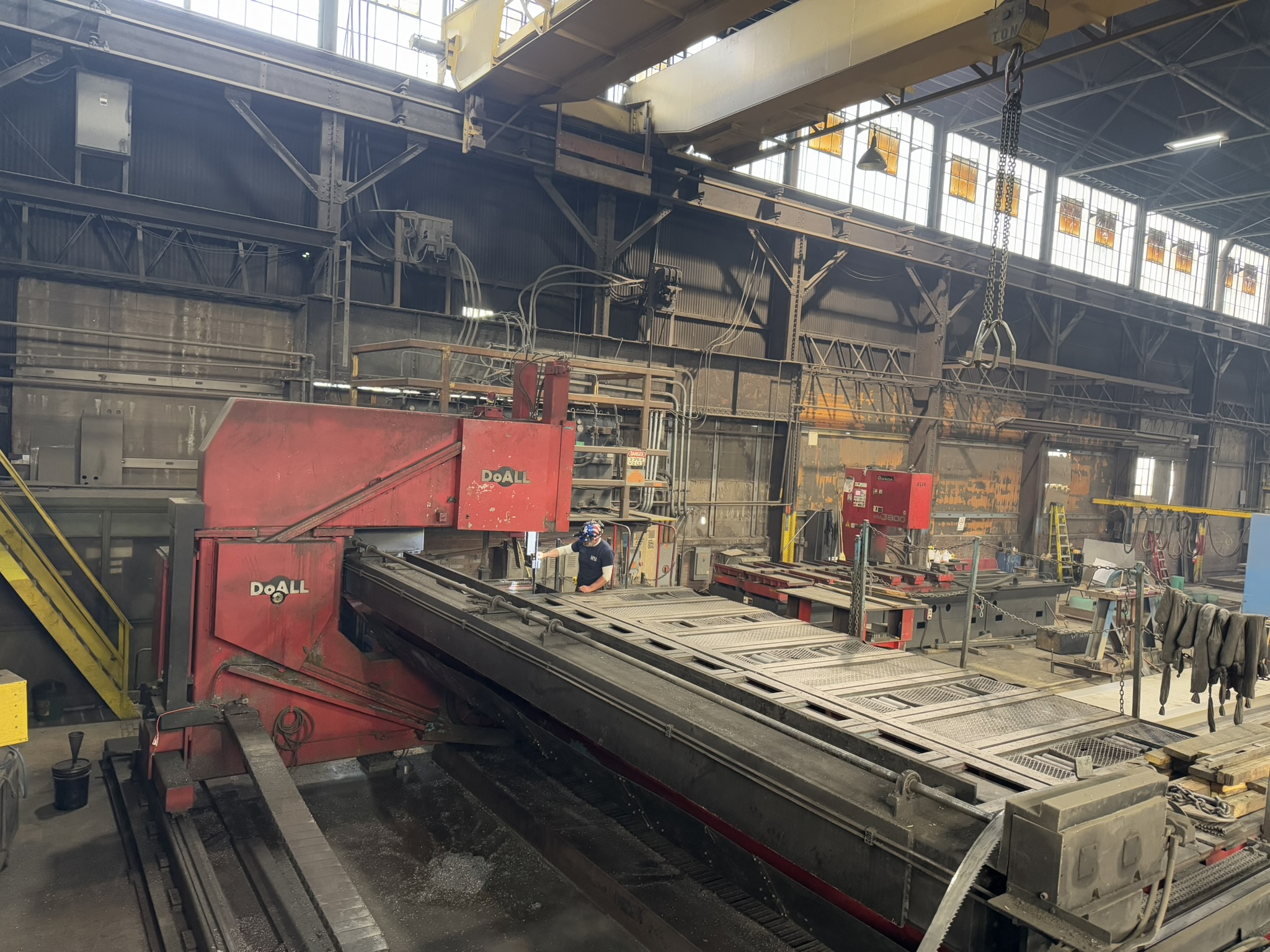 Bandsaw cutting through titanium billet at MSI Corporation