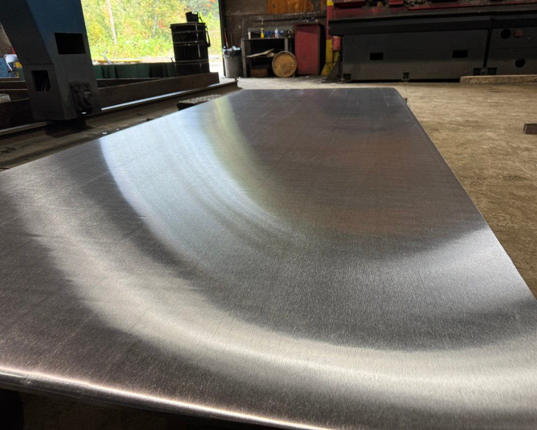 Ground titanium plate with uniform surface finish