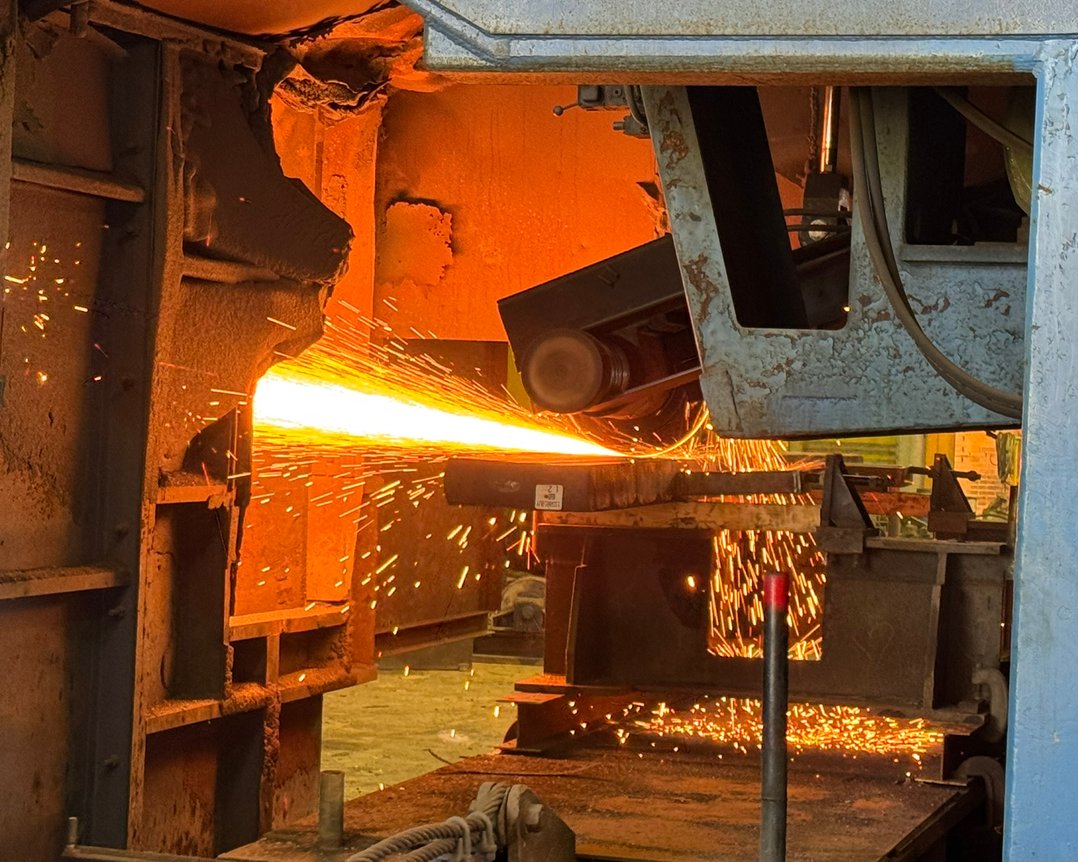 Midwest abrasive wheel grinder grinding a specialty-metal slab